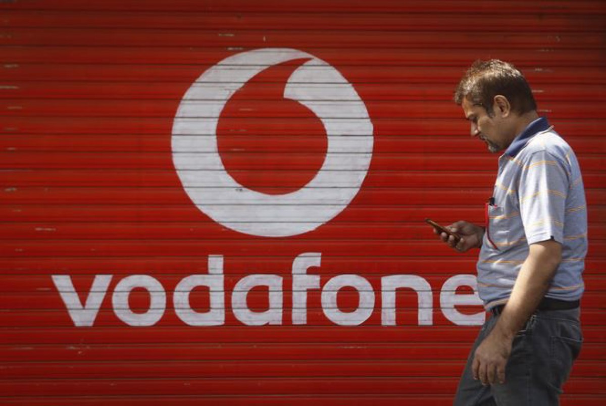 Un home passa per davant d'una botiga de Vodafone