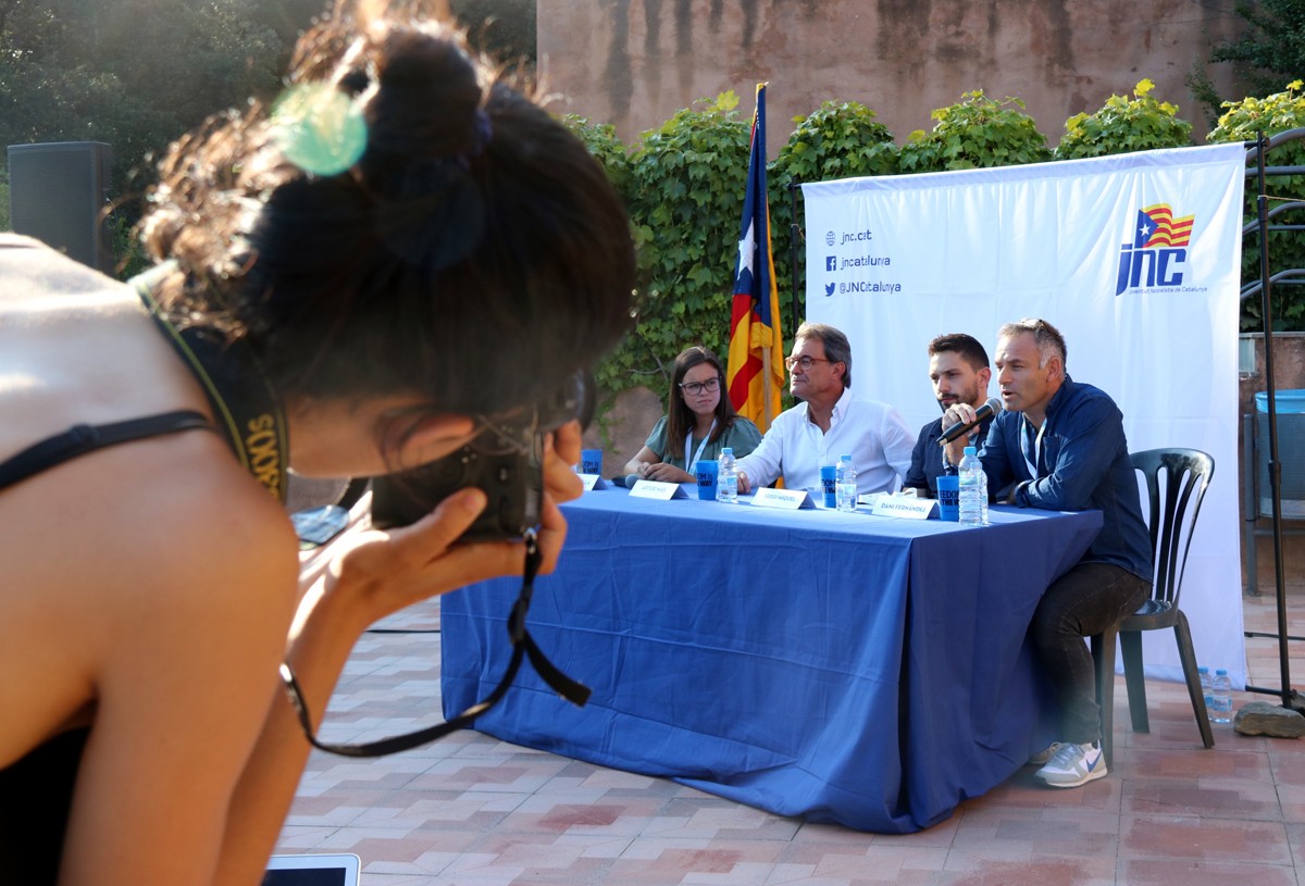 Una jove de les JNC fent una foto a Artur Mas en l'acte d'inauguració del 