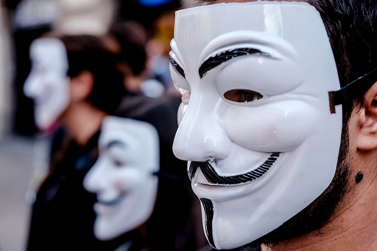 Diversos manifestants amb caretes d'Anonymous