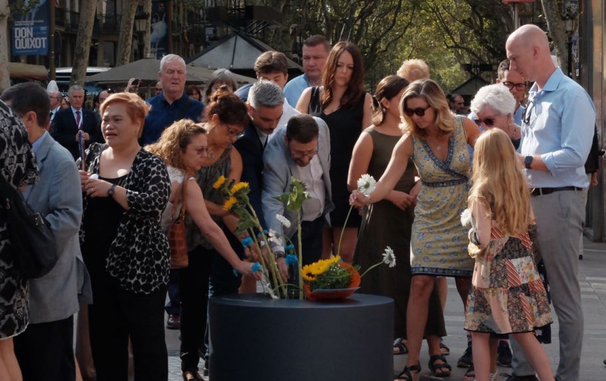 Víctimes i familiars en l'ofrena floral davant del mural de Joan Miró a la Rambla.
