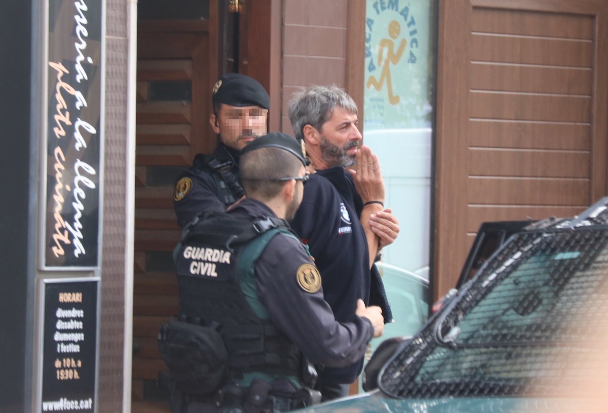 Dos agents de la Guàrdia Civil s'emporten un dels detinguts en l'operació Judes