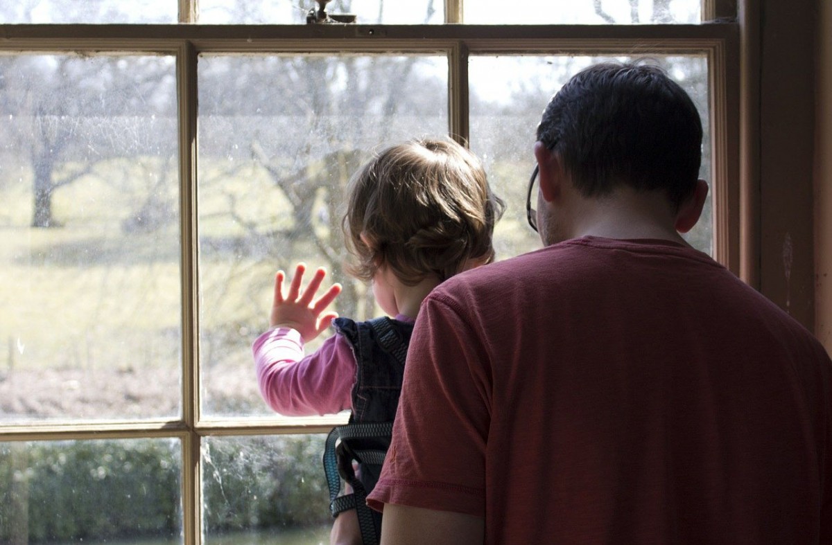 Un pare i la seva filla mirant per la finestra.