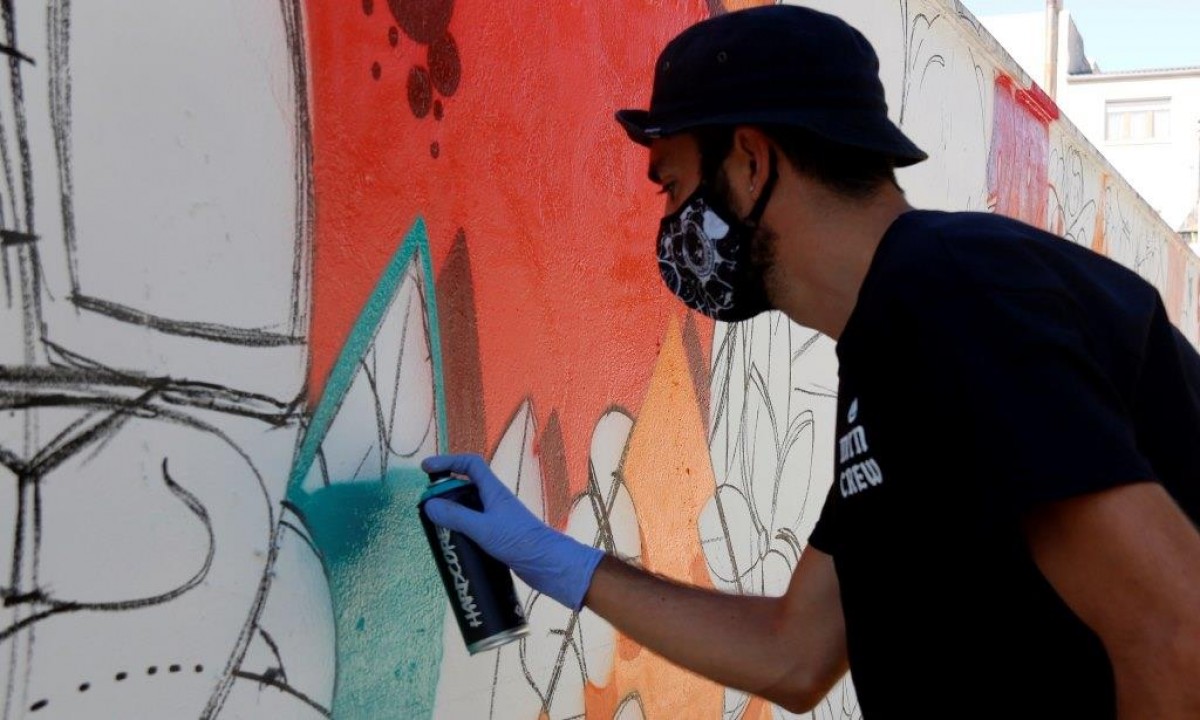 Un artista fent un mural a Penelles