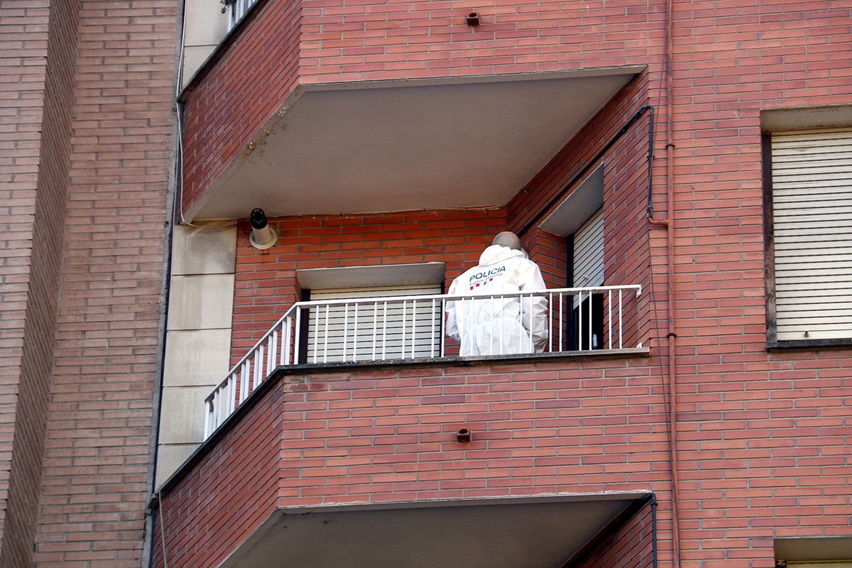 Un efectiu de la policia científica dels Mossos al balcó del pis de l'avinguda de les Garrigues de Lleida on ha tingut lloc l'homicidi.