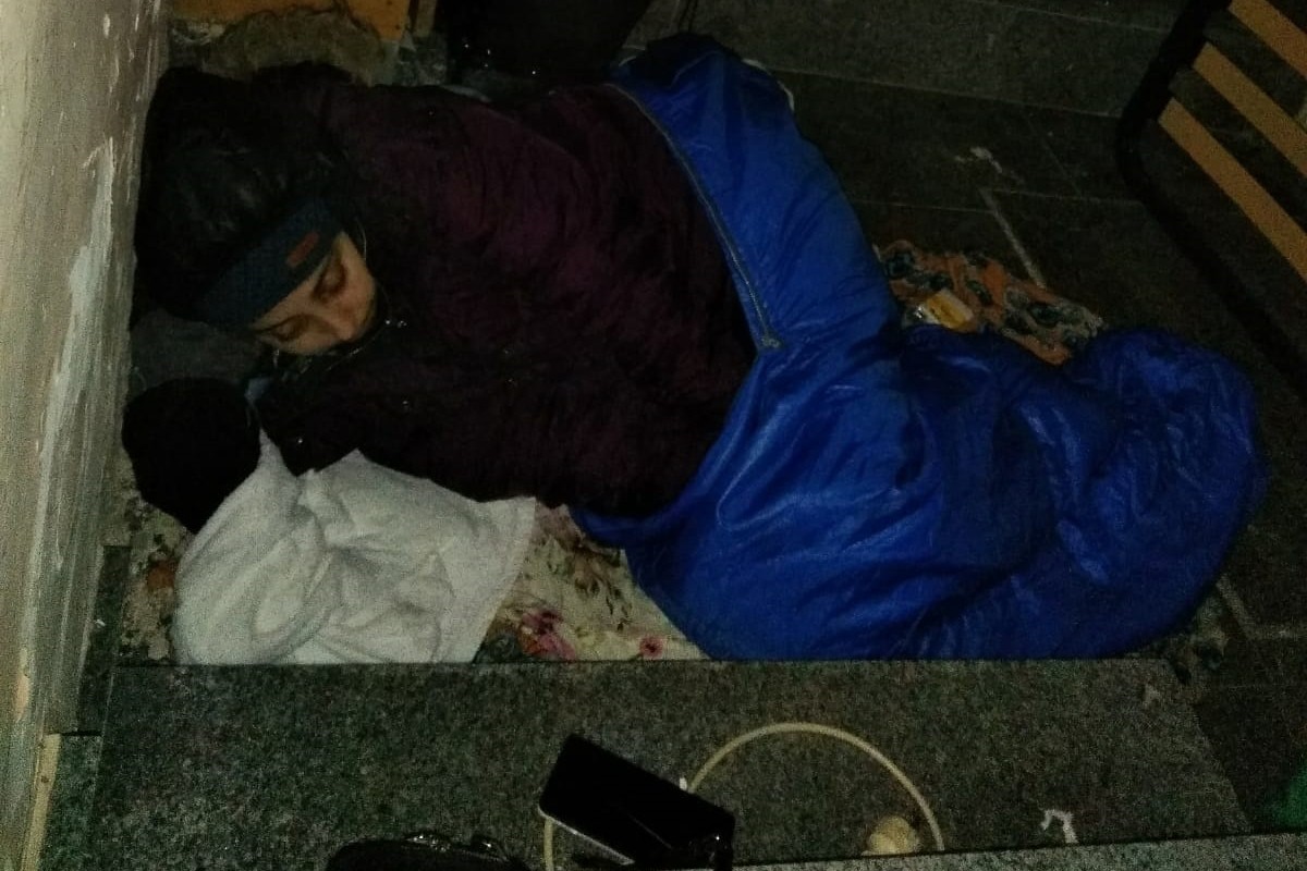 La dona, malalta, dormint en l'entrada d'un bloc que va trobar obert