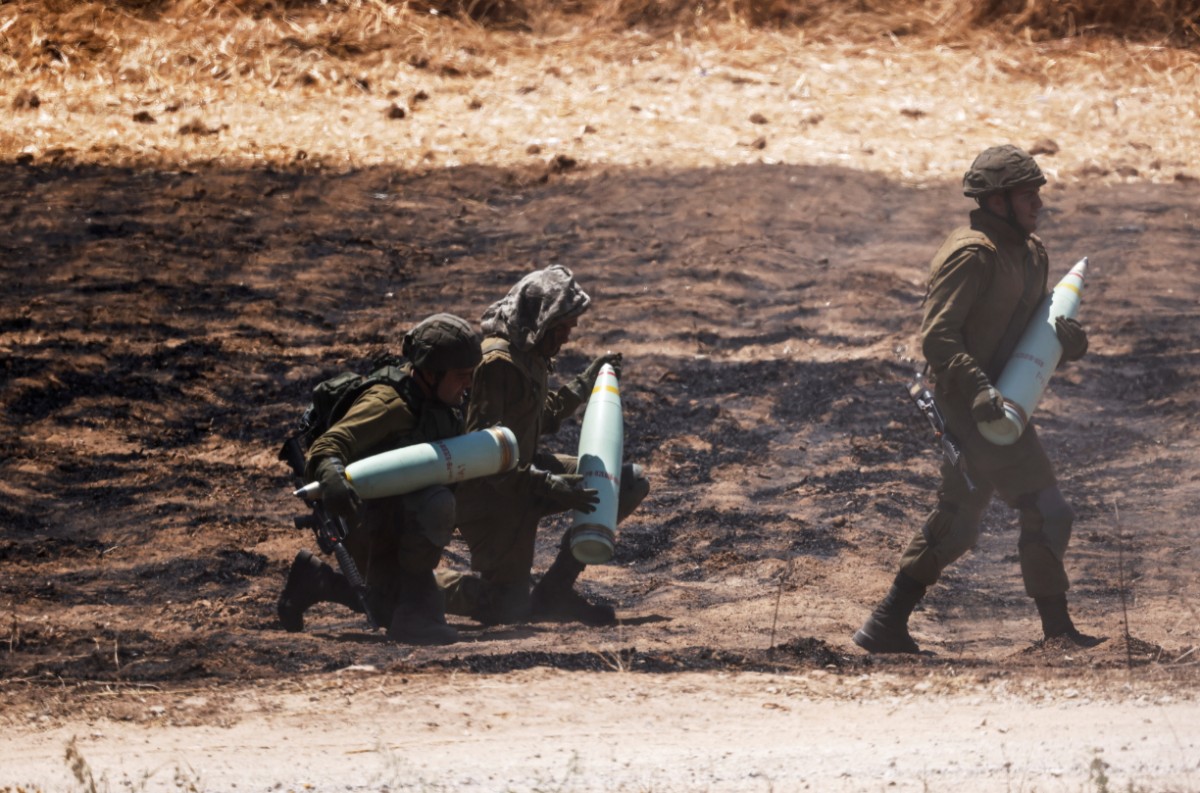 Soldats israelians portant projectils d'artilleria a una unitat pròxima a la frontera entre Israel i la Franja de Gaza