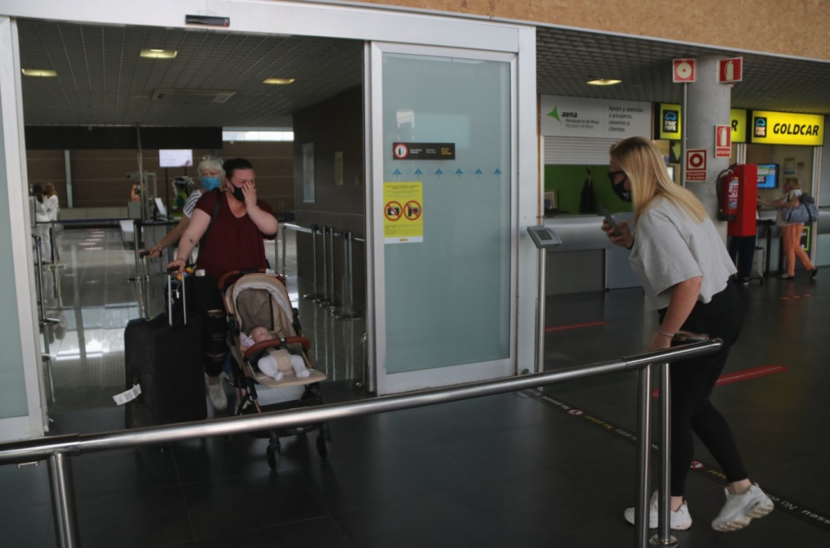 Una família que coneix per primera vegada la seva fillola, a la Terminal d'arribades de l'Aeroport de Reus