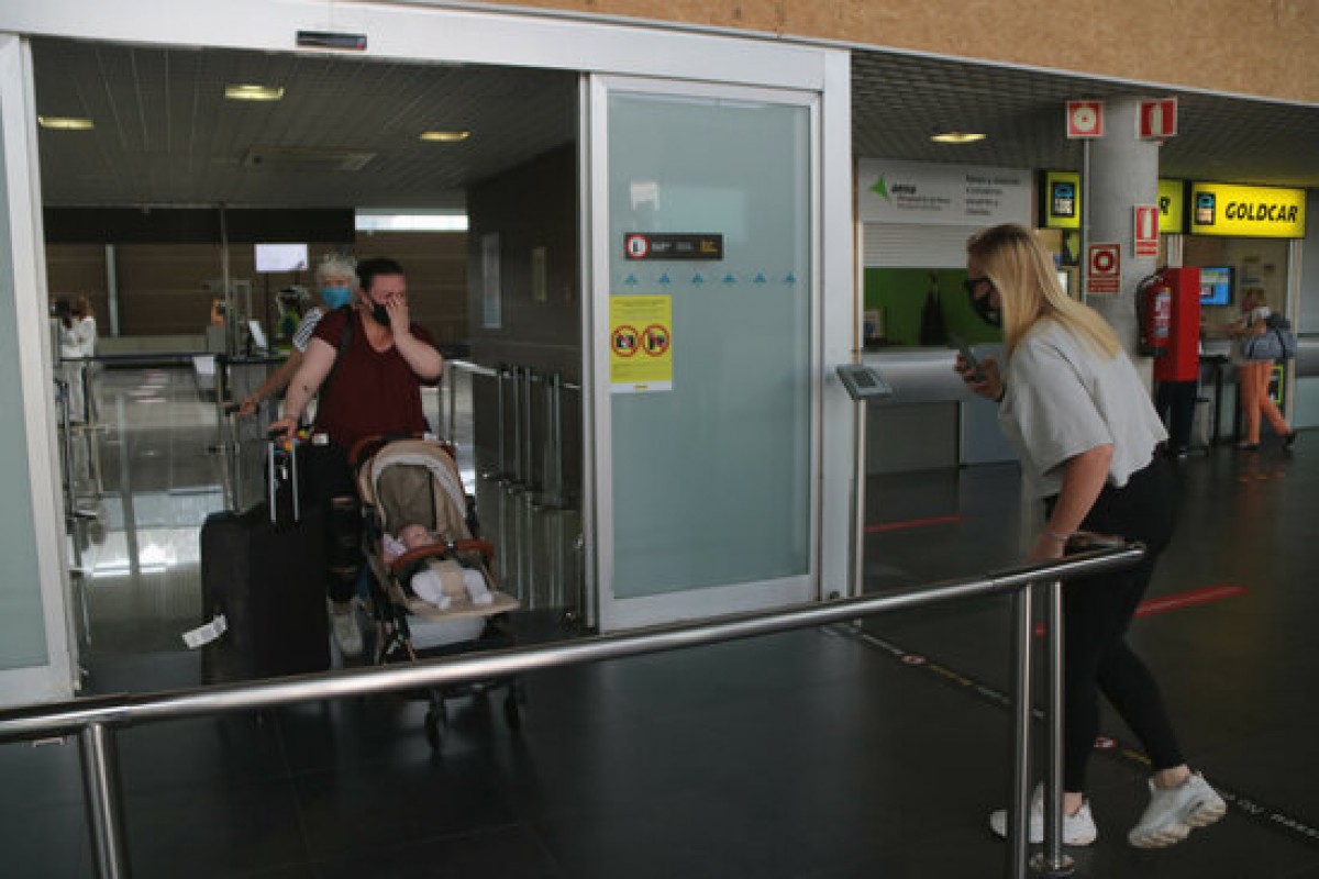 Una família que coneix per primera vegada la seva fillola, aquest dimarts al migdia a la Terminal d'arribades de l'Aeroport de Reus