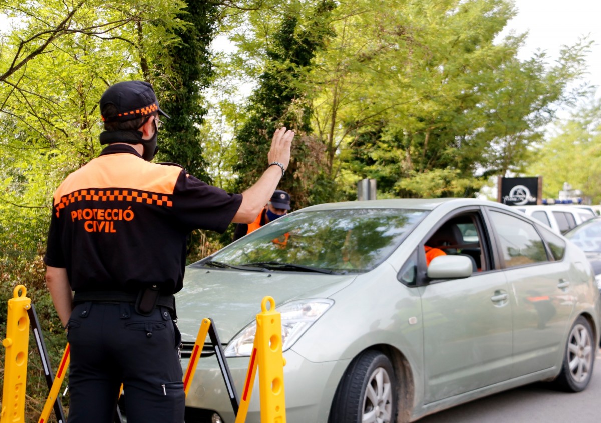 Voluntaris de Protecció Civil aturant els vehicles a la riera de Merlès