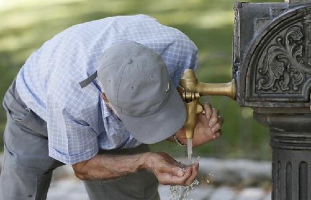 Un home bevent aigua a Lleida