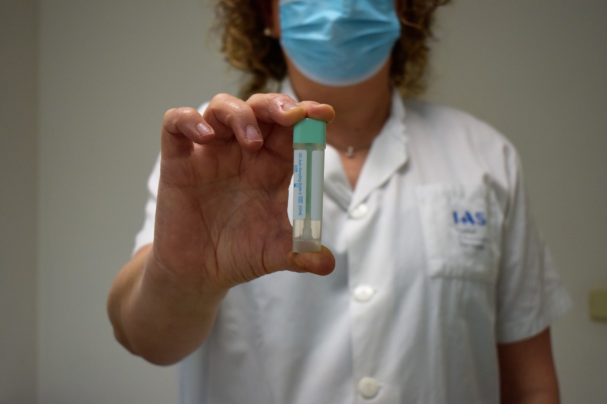 Una professional ensenya el kit per a fer el test de sang oculta en femta.