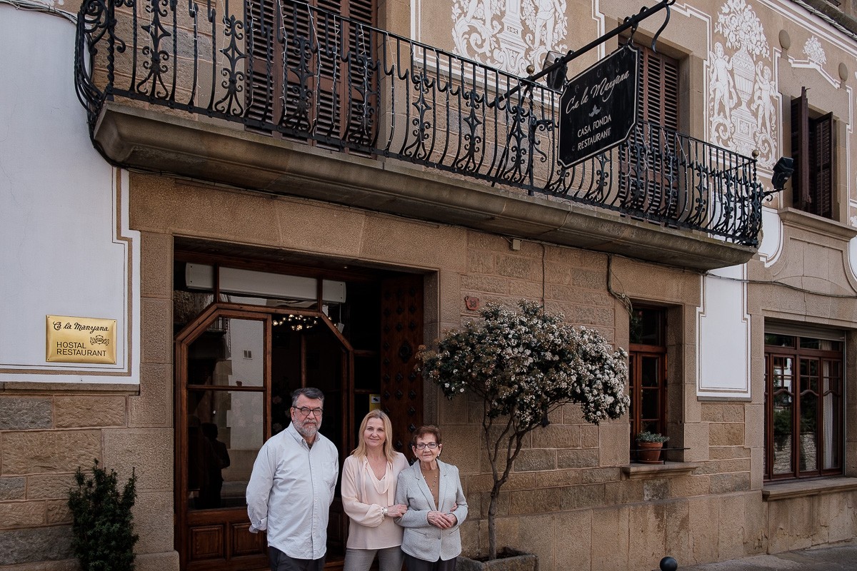 Maria Menció, Núria Isern i Silvino González fotografiats a l'entrada de Ca la Manyana.