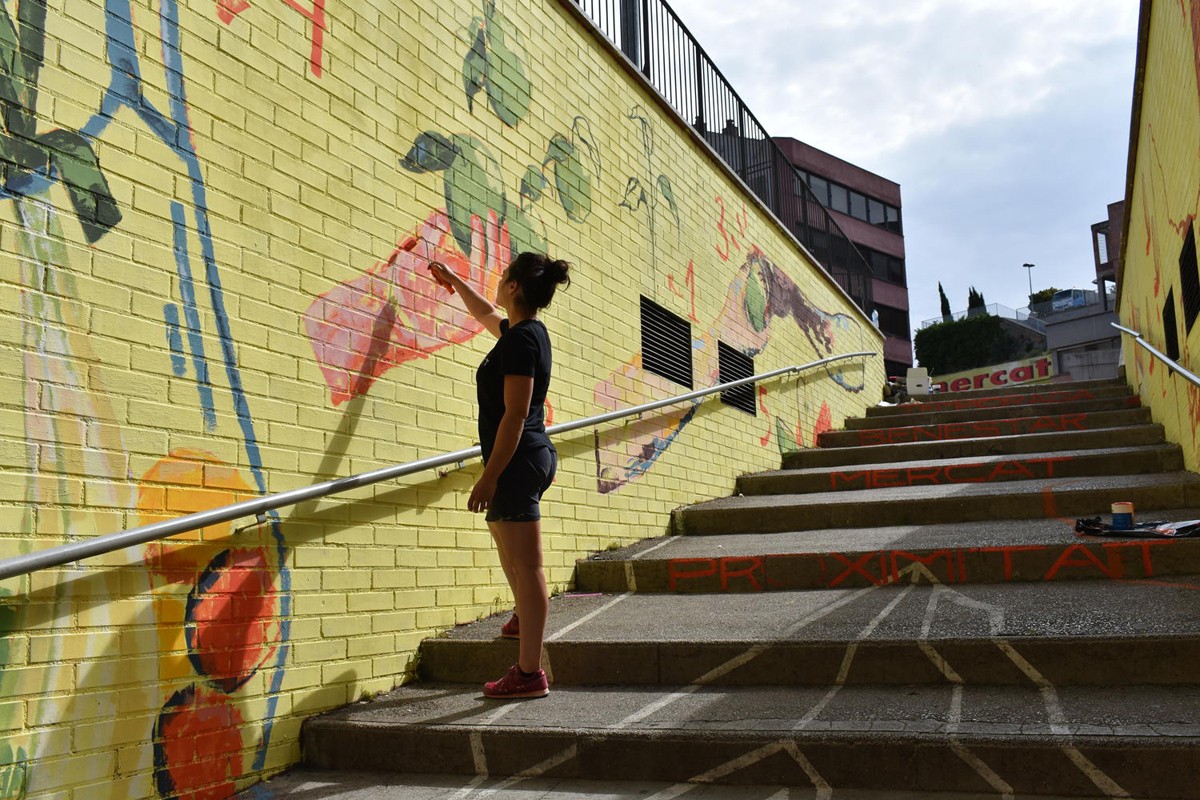 Sara Villarta pintant el mural al carrer de la Canal