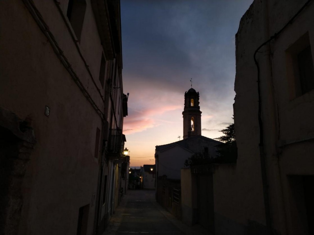 Imatge d'un vespre a Montferri, on pot veure's la silueta de l'Església de Sant Bartomeu