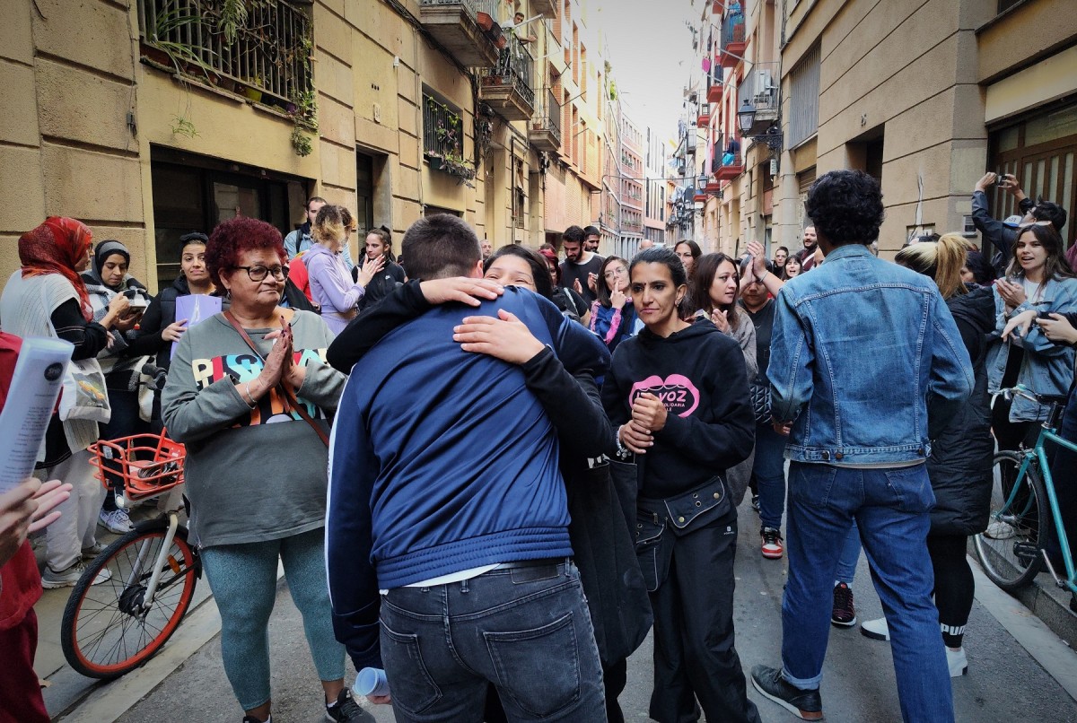 Una veïna mobilitzada abraça l'Àxel Altadill, després de suspendre uns dies un desnonament