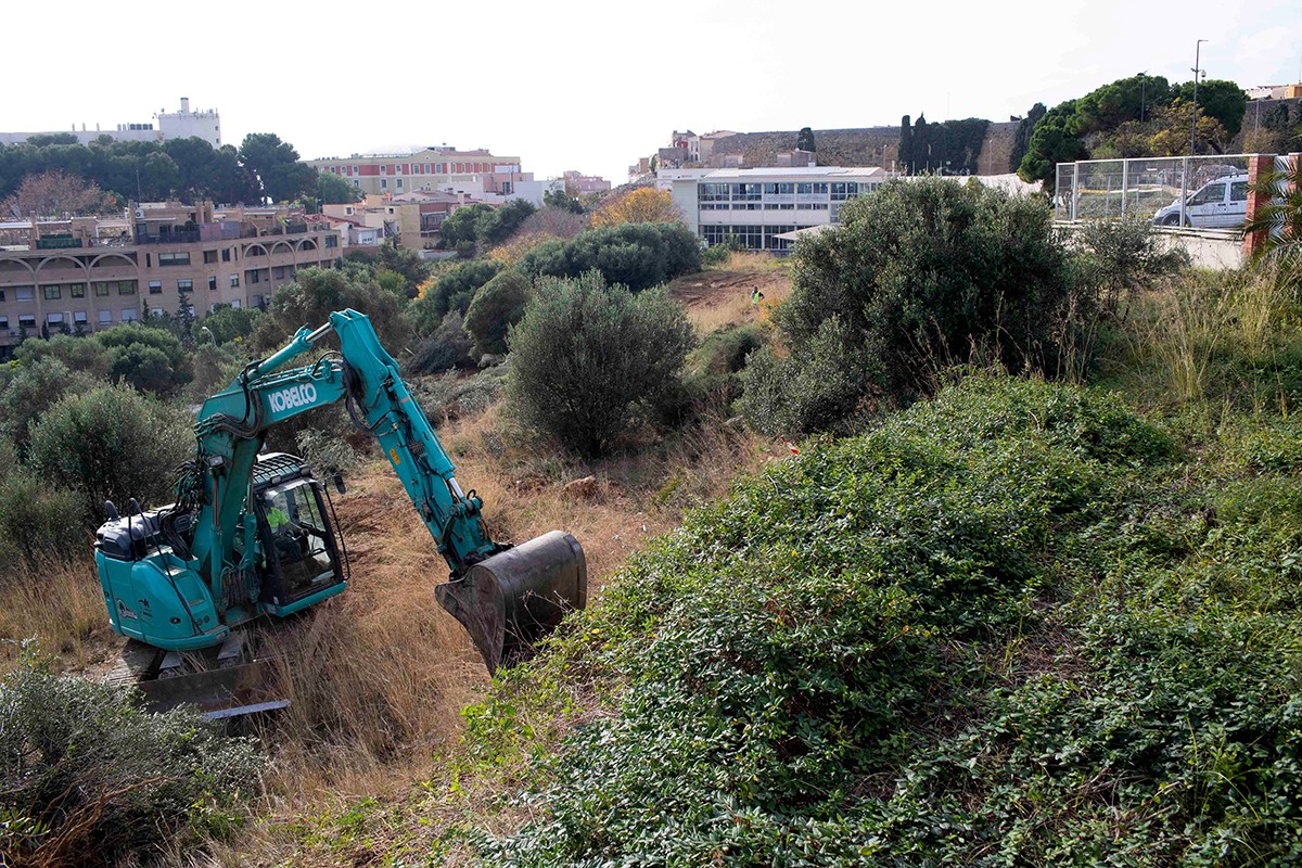 Una màquina excavadora treballant en les obres d'ampliació de l'aparcament municipal de Torroja de Tarragona.