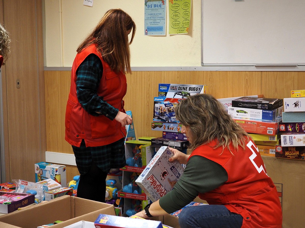 Voluntàries de Creu Roja endreçant les joguines de la campanya solidària de Nadal.