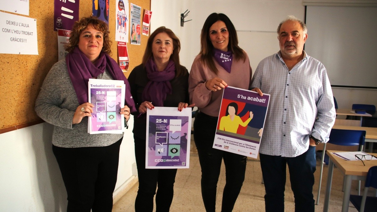 Imatge dels representants dels sindicats amb els cartells del 25N.
